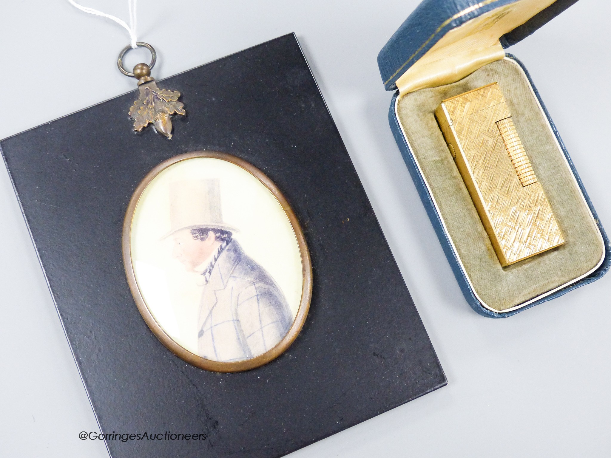 A 19th century watercolour of a gentleman in a top hat and boxed Dunhill lighter